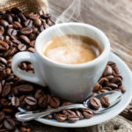 Espresso Coffee Cup With Beans On Vintage Table